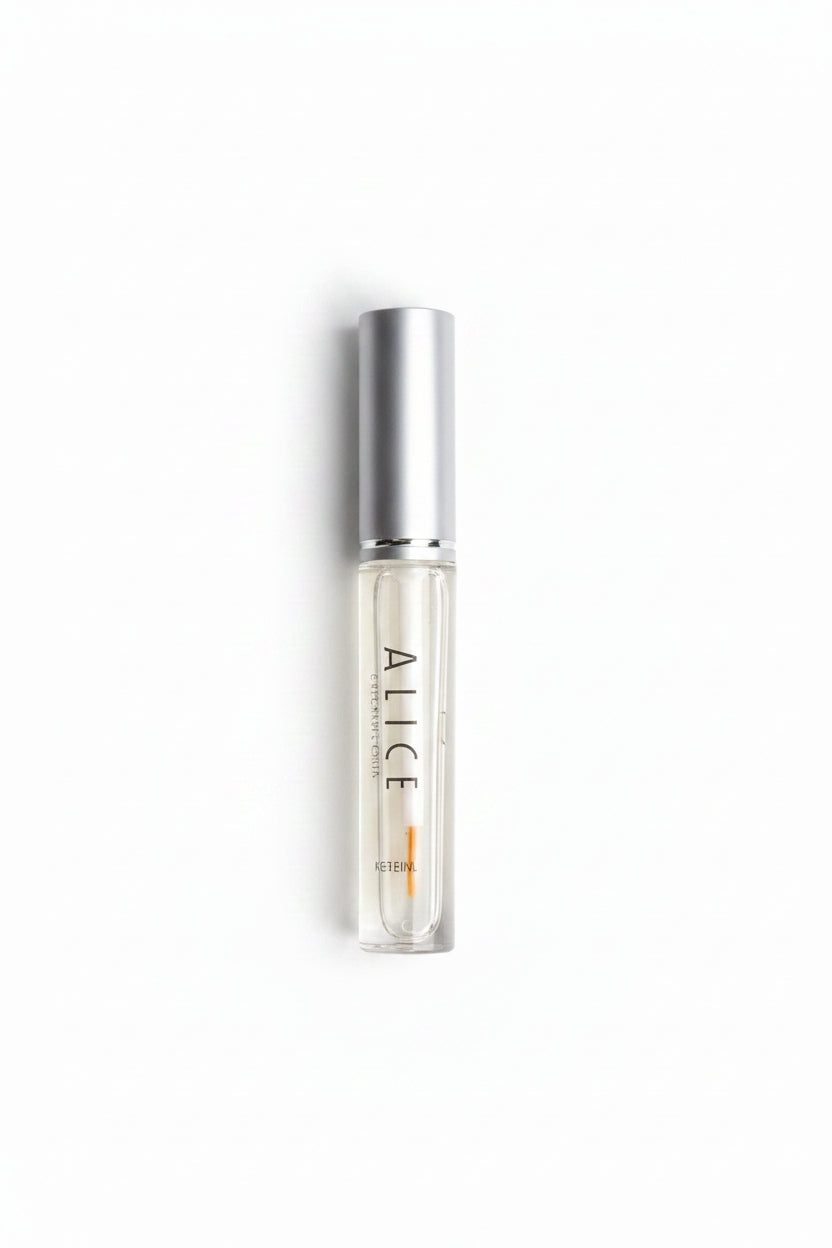 Small clear rollerball bottle with silver top on a gray background
